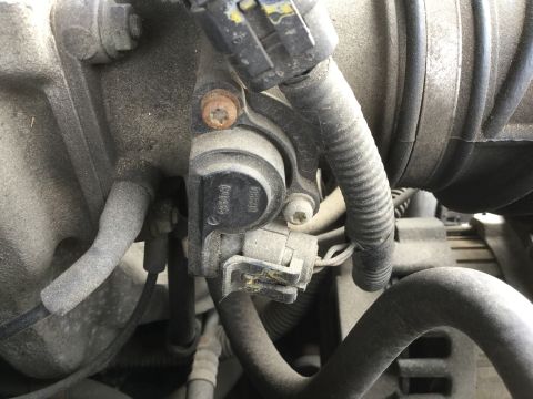 1995 Holden Astra - A close-up view of an engine component, showing part number '06B133062A' and other markings.