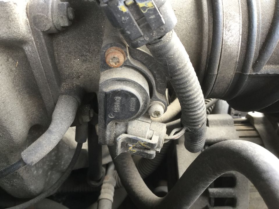 Close-up of engine part with visible text '06B133062A'