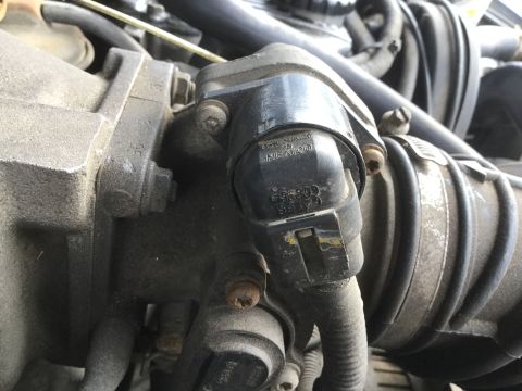 1995 Holden Astra - Engine component detail, likely a throttle body, with visible part numbers.