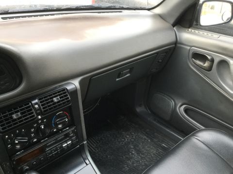 1995 Holden Astra - Interior view of a car's dashboard, center console, and door panel.