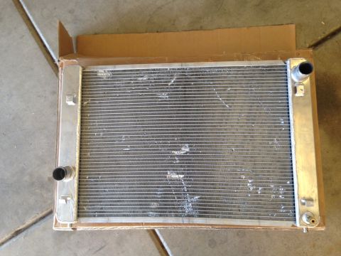 2010 Dodge Challenger - A radiator with aluminum tanks and a finned core is shown, packaged in cardboard.