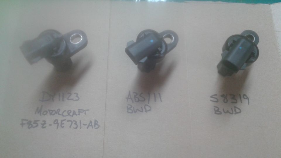 Three automotive sensors with handwritten labels: DY1123 Motorcraft F85Z-9E731-AB, ABS111 BWD, S8319 BWD