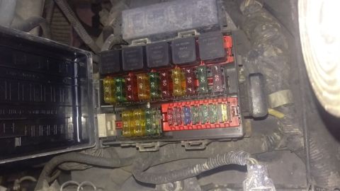 1994 Ford Bronco - Close-up view of a vehicle's fuse box, showing various fuses and relays.