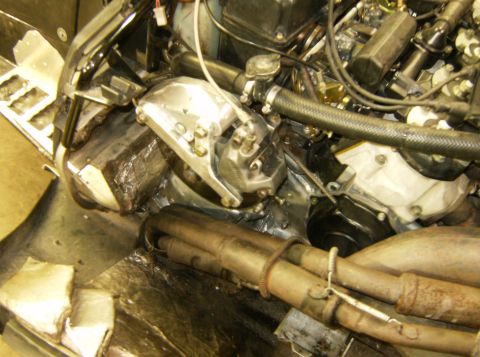 2000 Ford E350 - Close-up view of an engine compartment, showing exhaust pipes and various engine components.