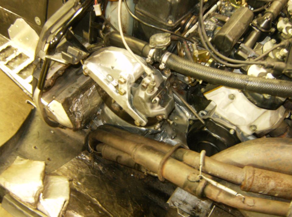 Engine compartment with exhaust pipes and metal shielding