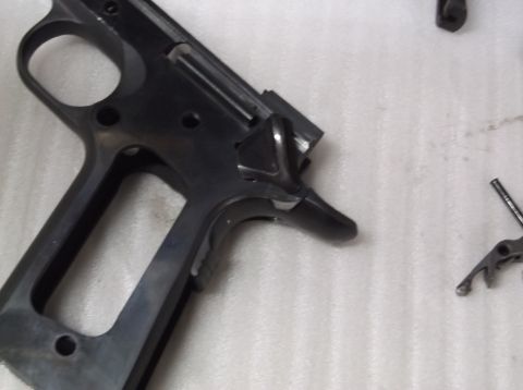 1995 Mercury Grand Marquis - Close-up view of a black gun frame, showing the trigger assembly and part of the slide mechanism.