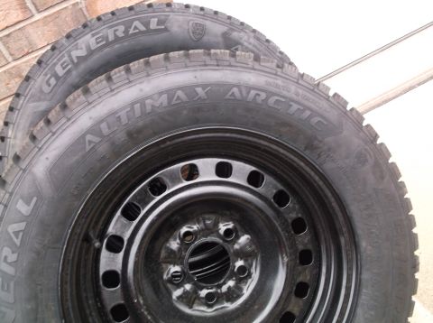 1999 Mercury Grand Marquis - A pair of General Altimax Arctic tires mounted on black steel wheels are shown.