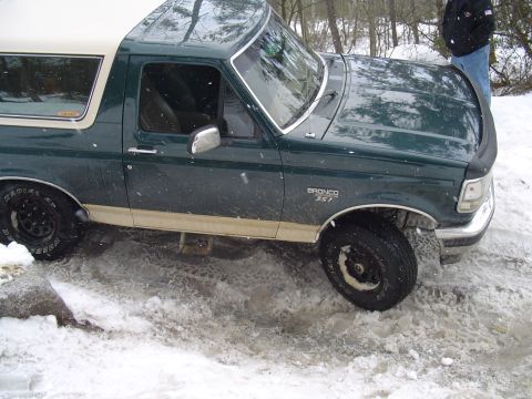 1993 Ford Bronco - This Ford Bronco is seen in a snowy environment, with a visible "BRONCO 5.7" badge on its fender.