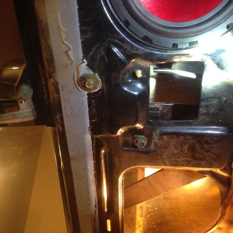 1993 Ford Bronco - Interior view of a car door's internal mechanism, showing linkages and a speaker.