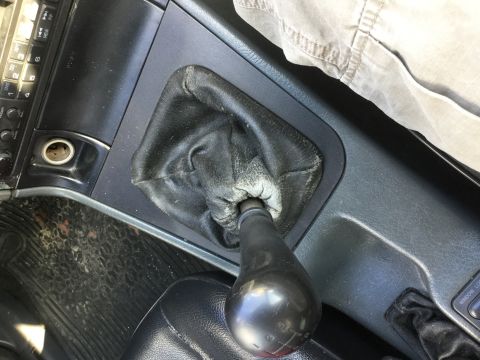 1995 Holden Astra - Close-up of the manual gear shifter and surrounding console in a vehicle interior.