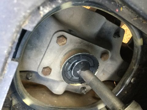 1995 Holden Astra - Close-up view of a vehicle's driveshaft U-joint, showing bolts and a rubber seal.