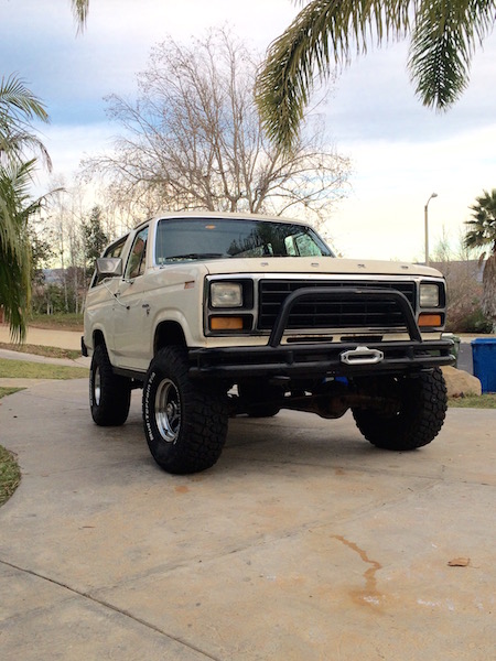 1981 Ford Bronco - This 1981 Ford Bronco, seen from a three-quarter front view, features a prominent bull bar and large off-road tires.