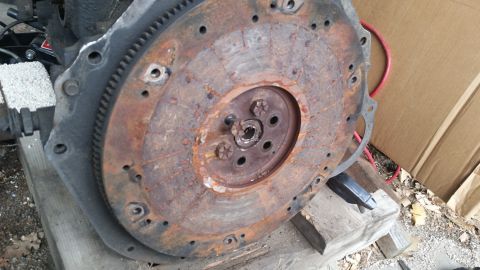 1981 Ford Bronco - This image shows a heavily rusted flywheel and part of an engine block, not a complete vehicle.