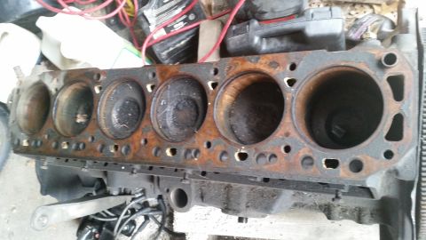 1981 Ford Bronco - A heavily rusted engine block is shown, with visible cylinder bores and signs of wear.