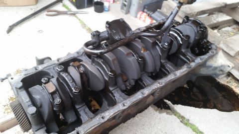 1981 Ford Bronco - Close-up view of an engine block, revealing the crankshaft and connecting rods.