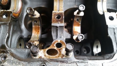 1981 Ford Bronco - Close-up view of an engine block's internal components, including connecting rods and bearing caps.