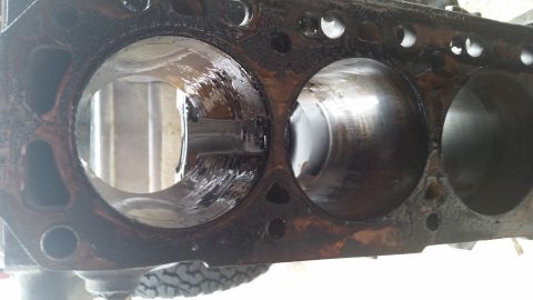 1981 Ford Bronco - Close-up view of engine block cylinders, showing internal wear and oil. The Supermotors.net logo is present in the lower right corner.