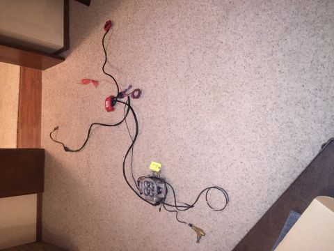 1982 Ford Bronco - A wiring harness and light assembly are laid out on a carpeted surface, with a Supermotors.net watermark visible.