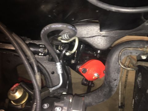 1982 Ford Bronco - Underside view of engine bay components with visible hoses and a red-colored part.
