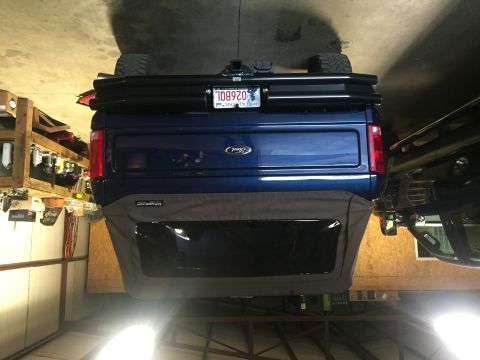 1982 Ford Bronco - Rear view of a blue Ford Bronco, showing its lifted stance and aftermarket accessories.