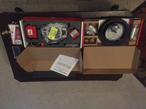 1982 Ford Bronco - This image shows a collection of vehicle parts, including hoses and electronic components, laid out in boxes.