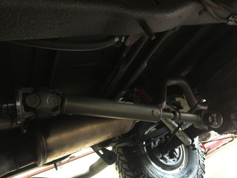 1982 Ford Bronco - This photo shows the driveshaft and exhaust system of a vehicle from underneath.