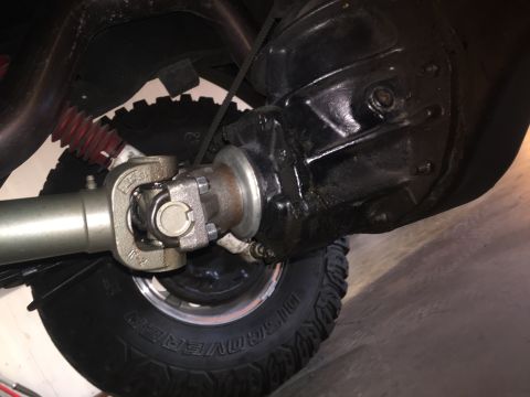 1982 Ford Bronco - Close-up view of the undercarriage drivetrain components, including a driveshaft and differential.