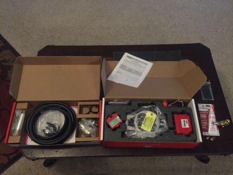 1982 Ford Bronco - Unboxed automotive components are laid out on a table, suggesting a recent purchase or upgrade.