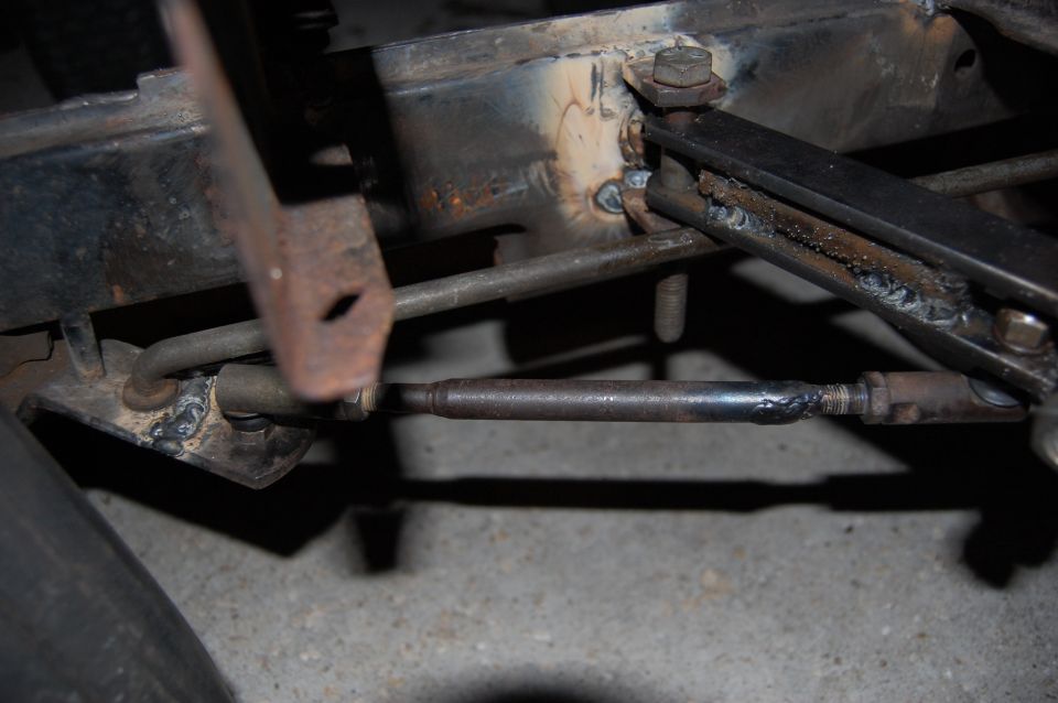Close-up of steering linkage with welds on a vehicle frame