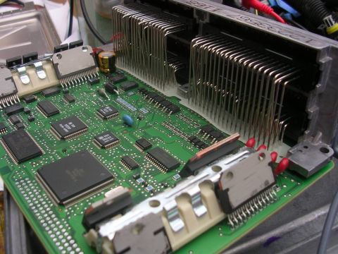 1976 Chevrolet Corvette - This electronic control unit features a complex circuit board with numerous components and a substantial heatsink for thermal management.