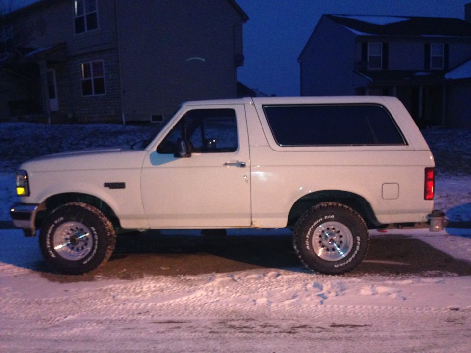 White 1993 Ford Bronco side view in snow