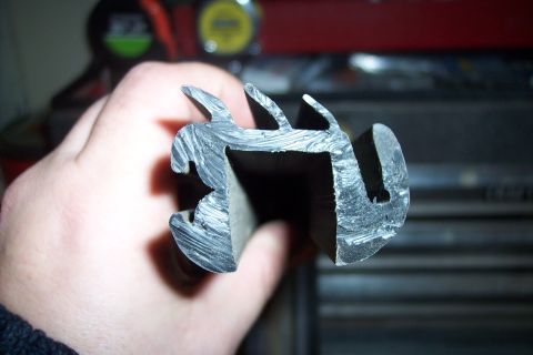 1990 Ford Bronco - A rubber gasket profile is examined, with visible cut marks and internal channels.