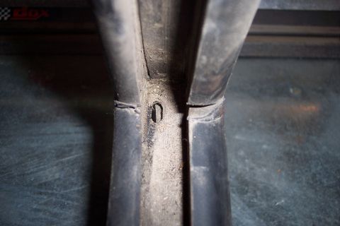 1990 Ford Bronco - Detail of a slider gasket, showing wear and a screw hole, likely from a vehicle door or window assembly.