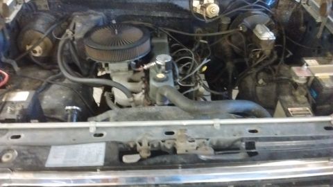 1985 Ford Bronco - The engine bay of a vehicle, showing the V8 engine components and wiring.