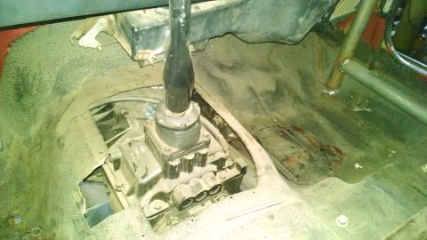 1985 Jeep CJ7 - The dusty interior of a Jeep shows a transmission shifter and a roll cage, with no clear year identification.