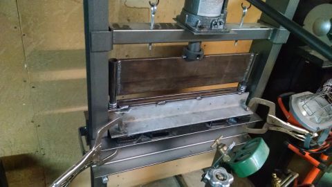 1985 Jeep CJ7 - A metal bending machine is set up in a workshop, ready for use.