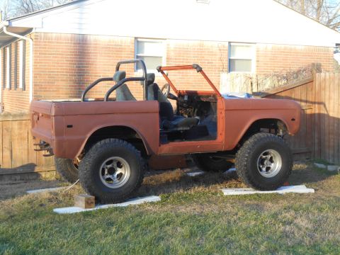 1972 Ford Bronco - This 1972 Ford Bronco is undergoing restoration, with its doors removed and sitting on blocks in a grassy yard.