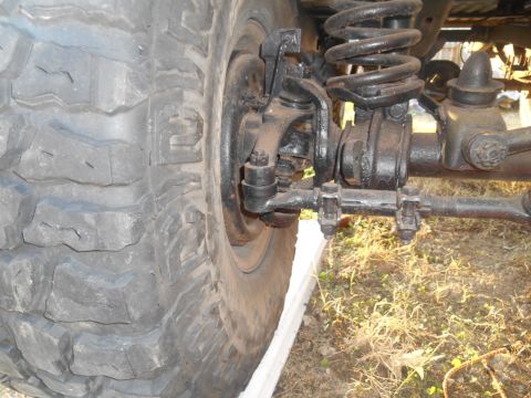 1972 Ford Bronco - Detail of the front suspension and tire, with 'SUPER MOTORS' visible in the lower right corner.