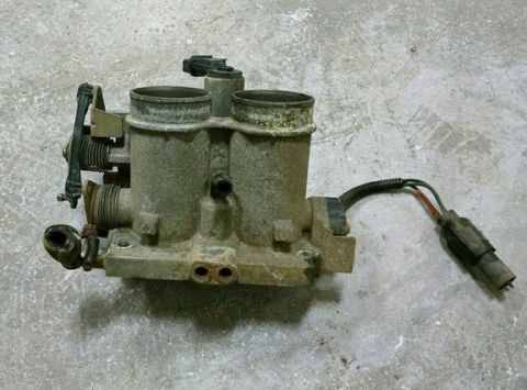 1990 Ford Bronco - Throttle body assembly with dual intake ports and wiring harness.