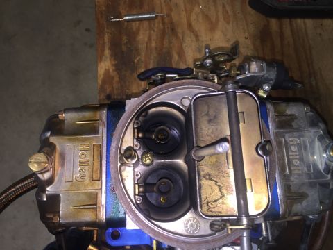 1982 Ford Bronco - A Holley carburetor, a component for a vehicle, is shown up close with visible branding and internal mechanisms.