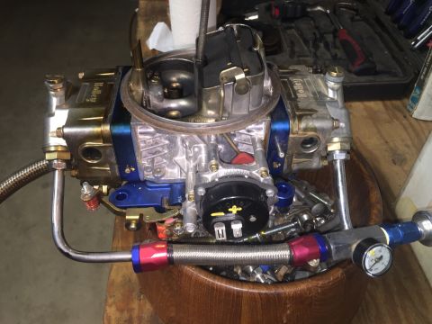 1982 Ford Bronco - A Holley carburetor, likely a performance upgrade, is shown in detail with braided fuel lines and a pressure gauge.