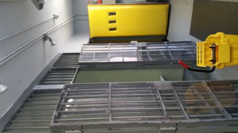 1991 Ford LTD Crown Victoria - Photo of a jail corridor with open barred cell doors, a yellow locker and a mop bucket.