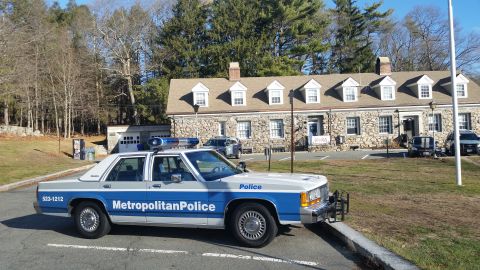 1991 Ford LTD Crown Victoria - Photo of a Metropolitan Police Ford Crown Victoria cruiser, front three-quarter view at a stone station.