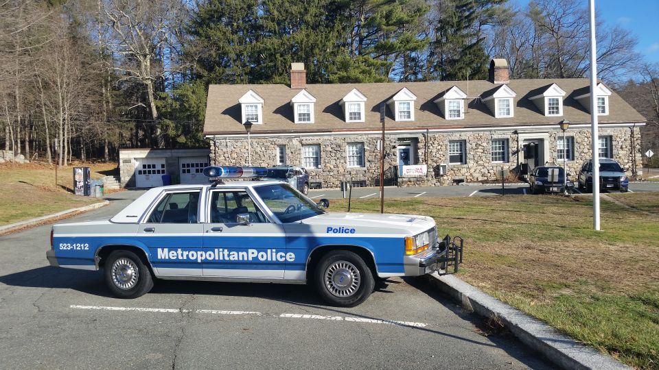 Metropolitan Police Ford Crown Victoria cruiser parked outside stone station