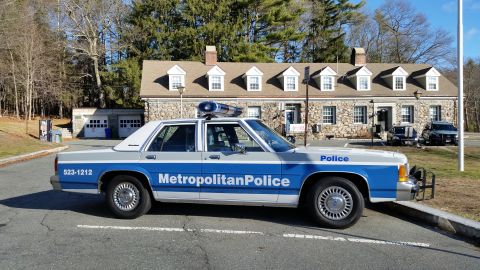 1991 Ford LTD Crown Victoria - Photo of a Metropolitan Police Ford Crown Victoria cruiser with push bar parked at a stone station.