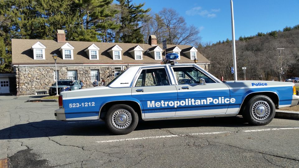 Blue and white Metropolitan Police Ford Crown Victoria cruiser, side profile