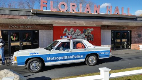 1991 Ford LTD Crown Victoria - Photo of a vintage Ford Metropolitan Police patrol car parked in front of Florian Hall, not a technical document.