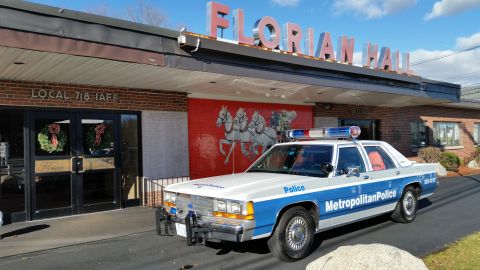 1991 Ford LTD Crown Victoria - Photo of a vintage Ford Metropolitan Police patrol car parked at the Florian Hall entrance, not a technical document.
