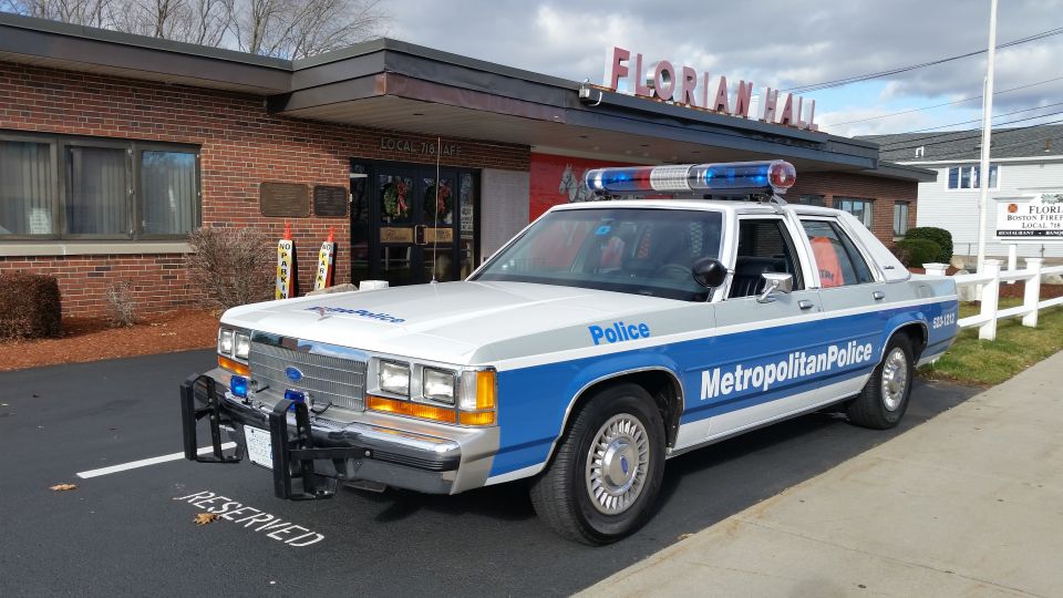 Front three-quarter view of Metropolitan Police Ford sedan at Florian Hall
