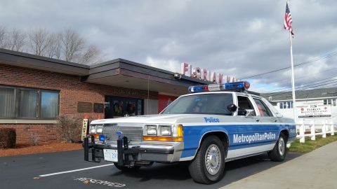 1991 Ford LTD Crown Victoria - Photo of a blue-and-white Ford Crown Victoria police car parked outside Florian Hall, not a technical document.